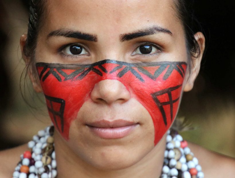 Porträt einer Frau mit traditioneller Gesichtsbemalung im Amazonasgebiet